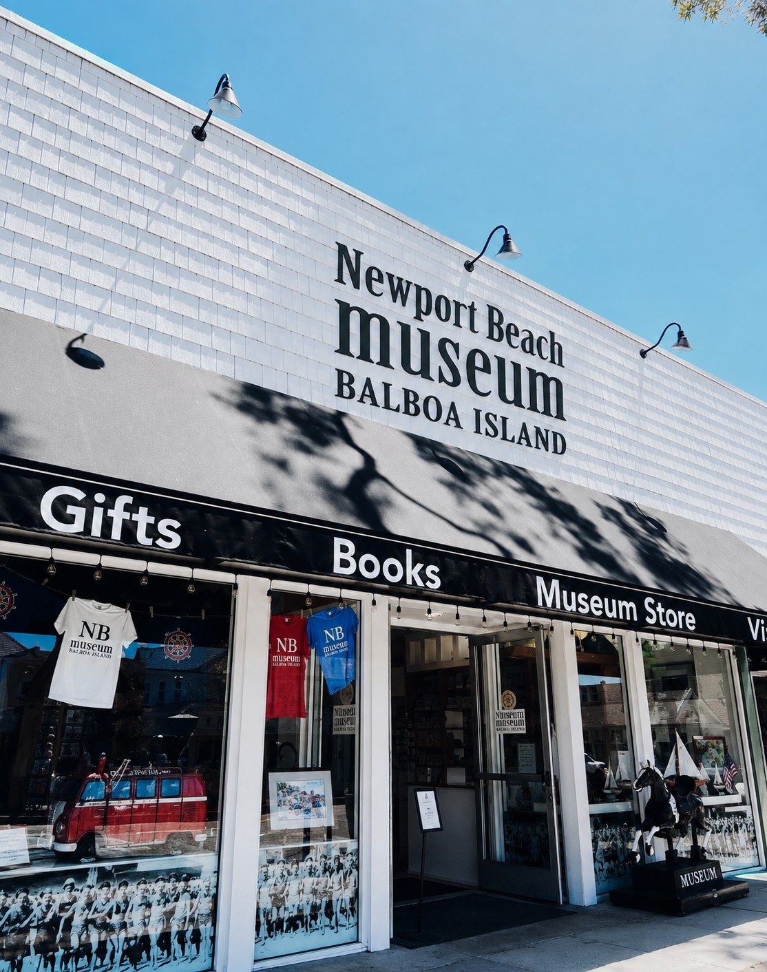 A storefront with a sign reading Newport Beach Museum Balboa Island, Gifts, Books and Museum Store.