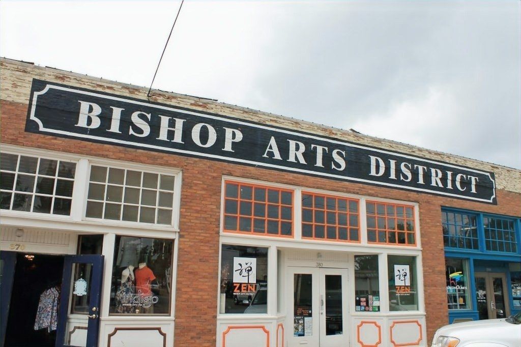 A brick building with a large sign reading Bishop Arts District across its top.