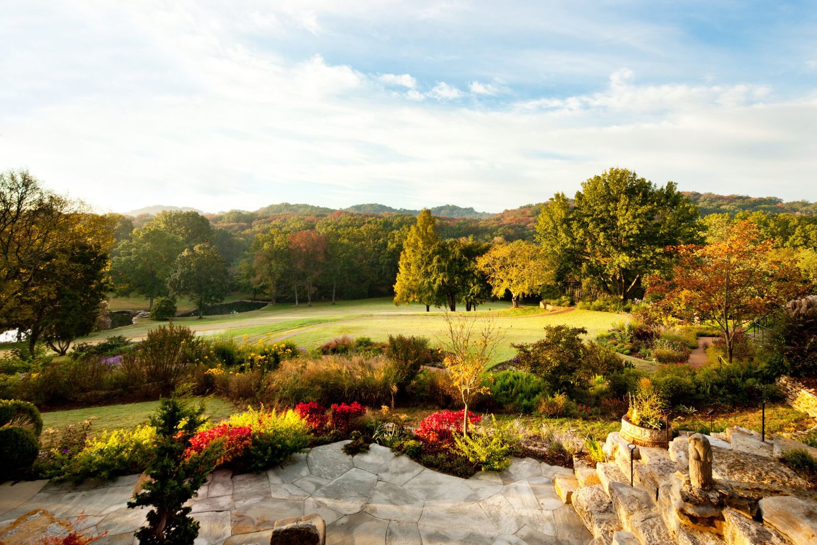 Autumn perennial garden with rock features and rolling hills beyond