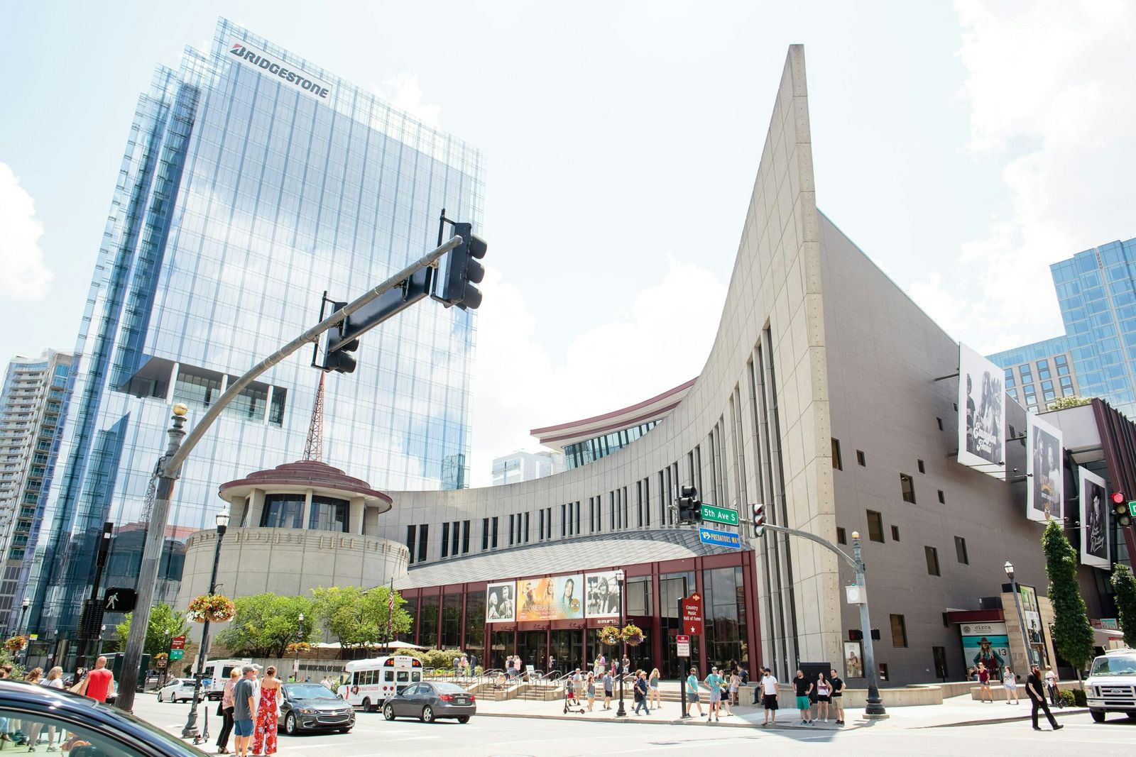 Exterior of the Country Music Hall of Fame building with a curved wall and glass towers behind