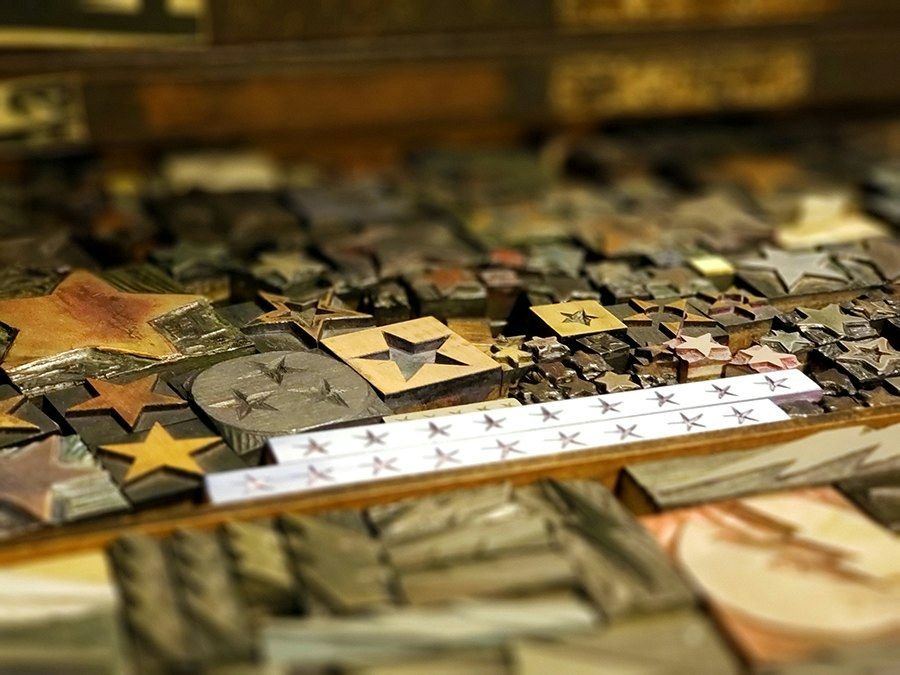 Close-up of antique wood and metal printing type blocks including star shapes