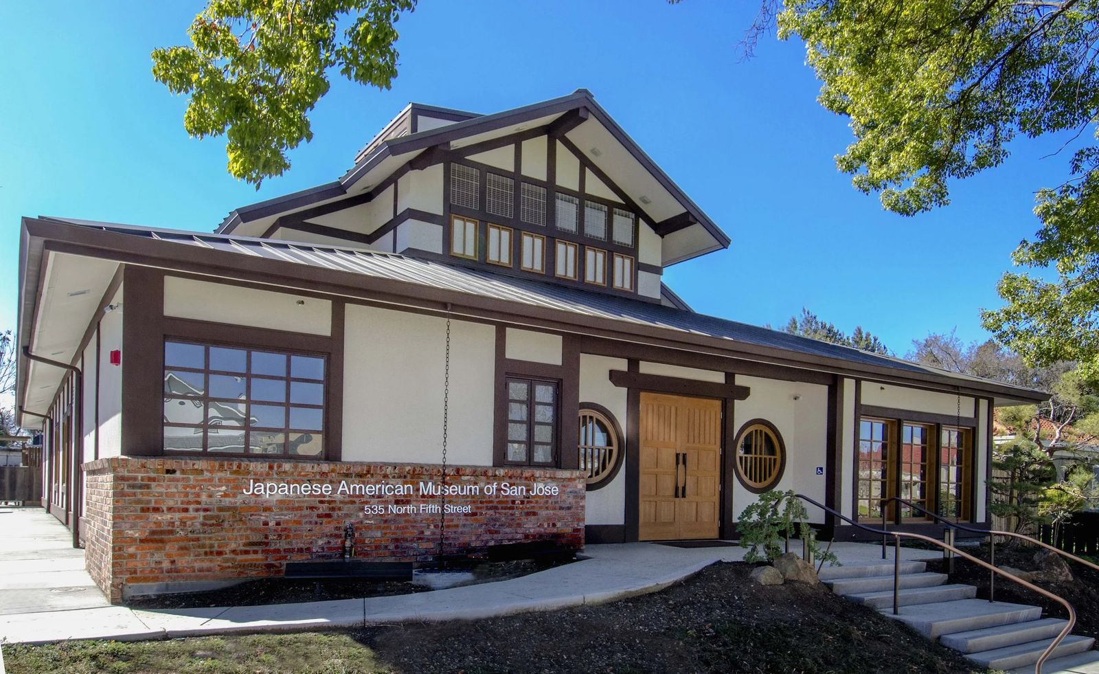 Exterior of the Japanese American Museum of San Jose, a wood-and-brick building with a tiled roof