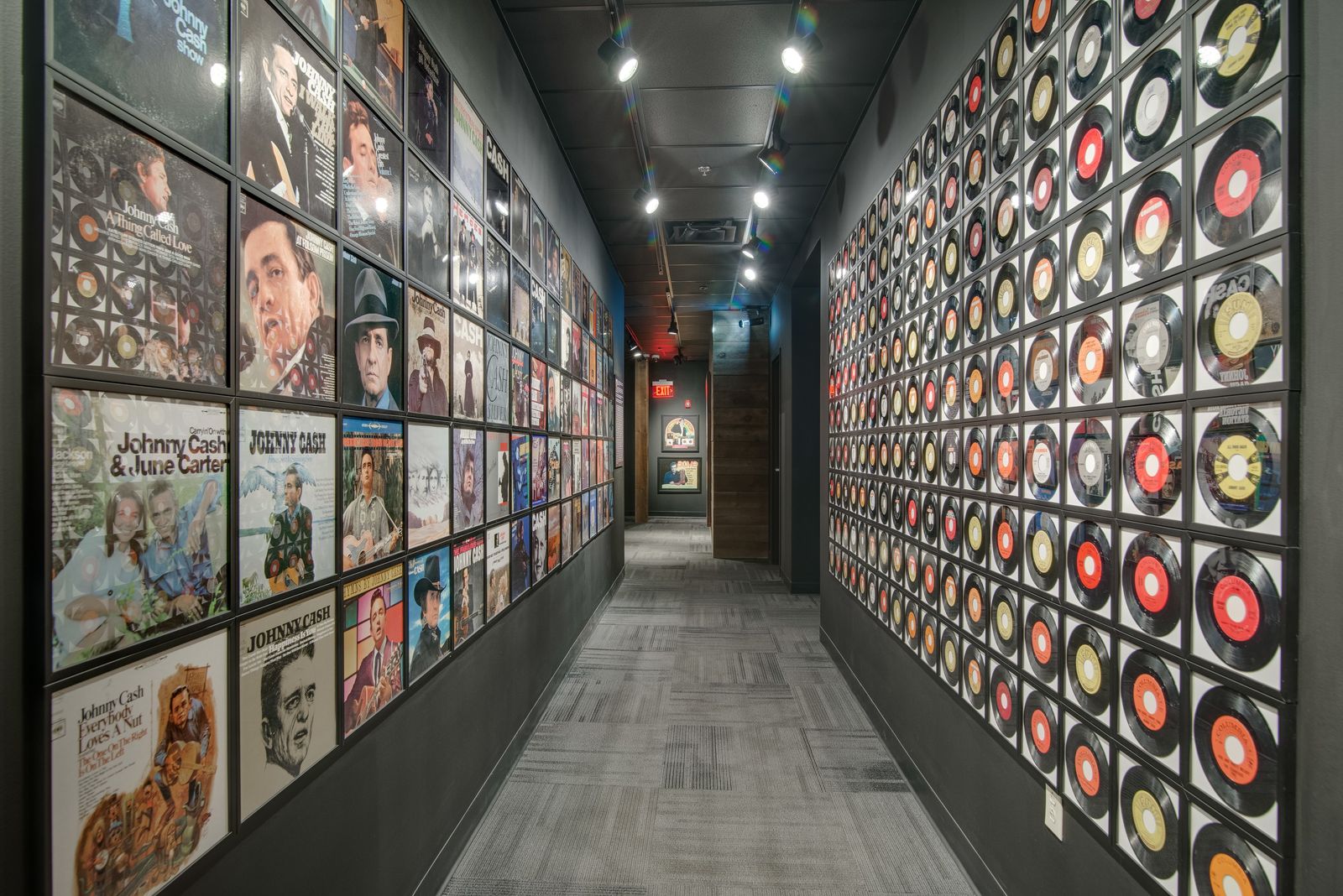 Museum hallway lined with framed records and album covers on both walls
