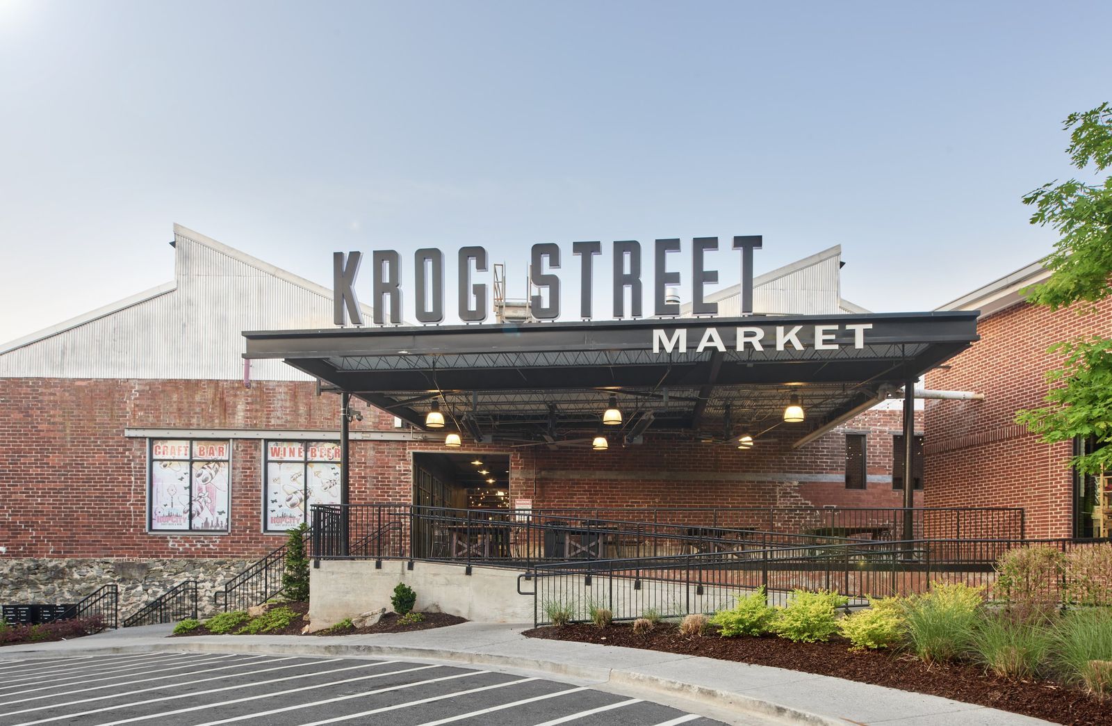 The brick and steel entrance of Krog Street Market with its name sign over the awning
