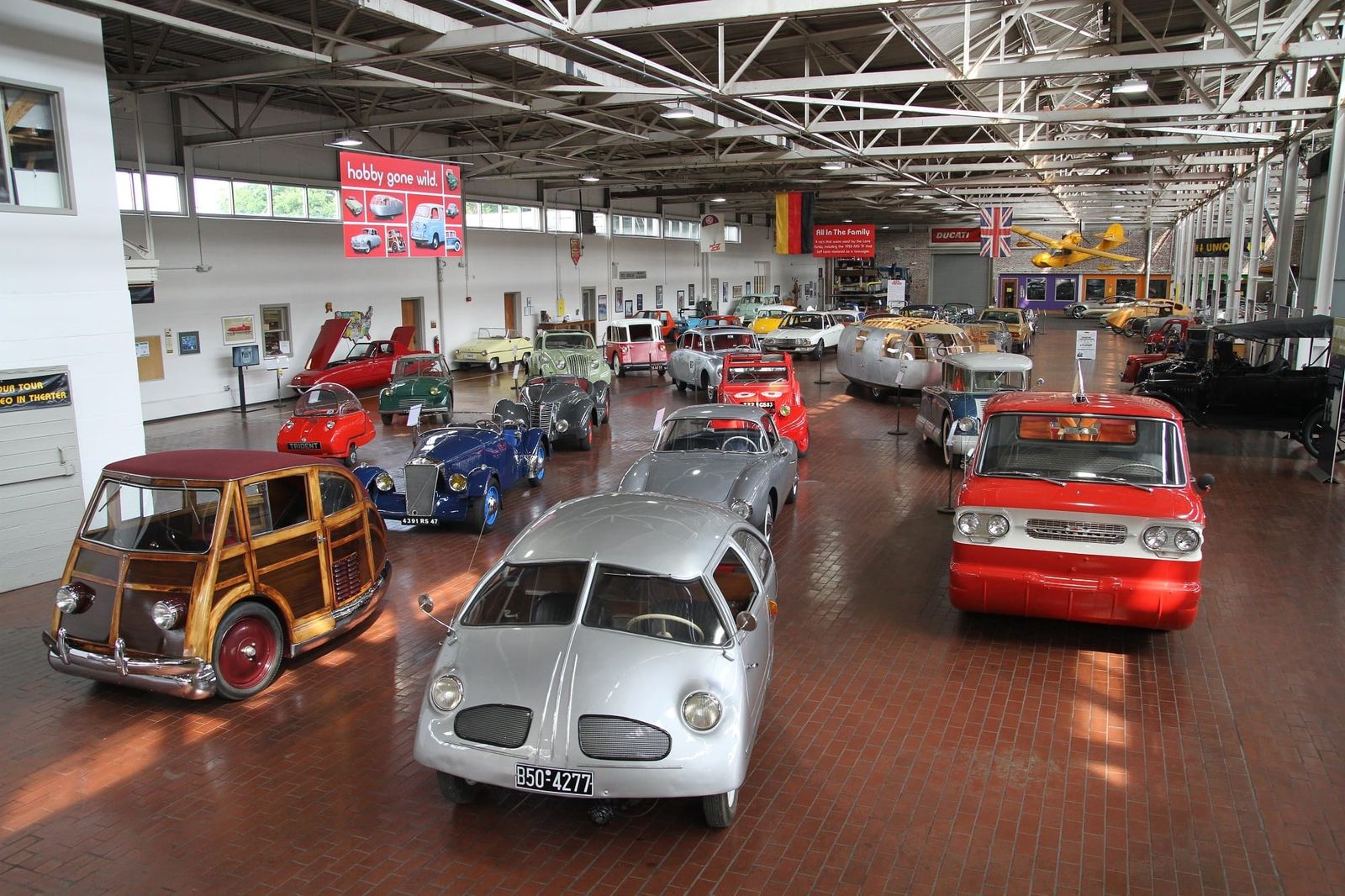 Wide view of the museum floor with rows of vintage and unusual cars