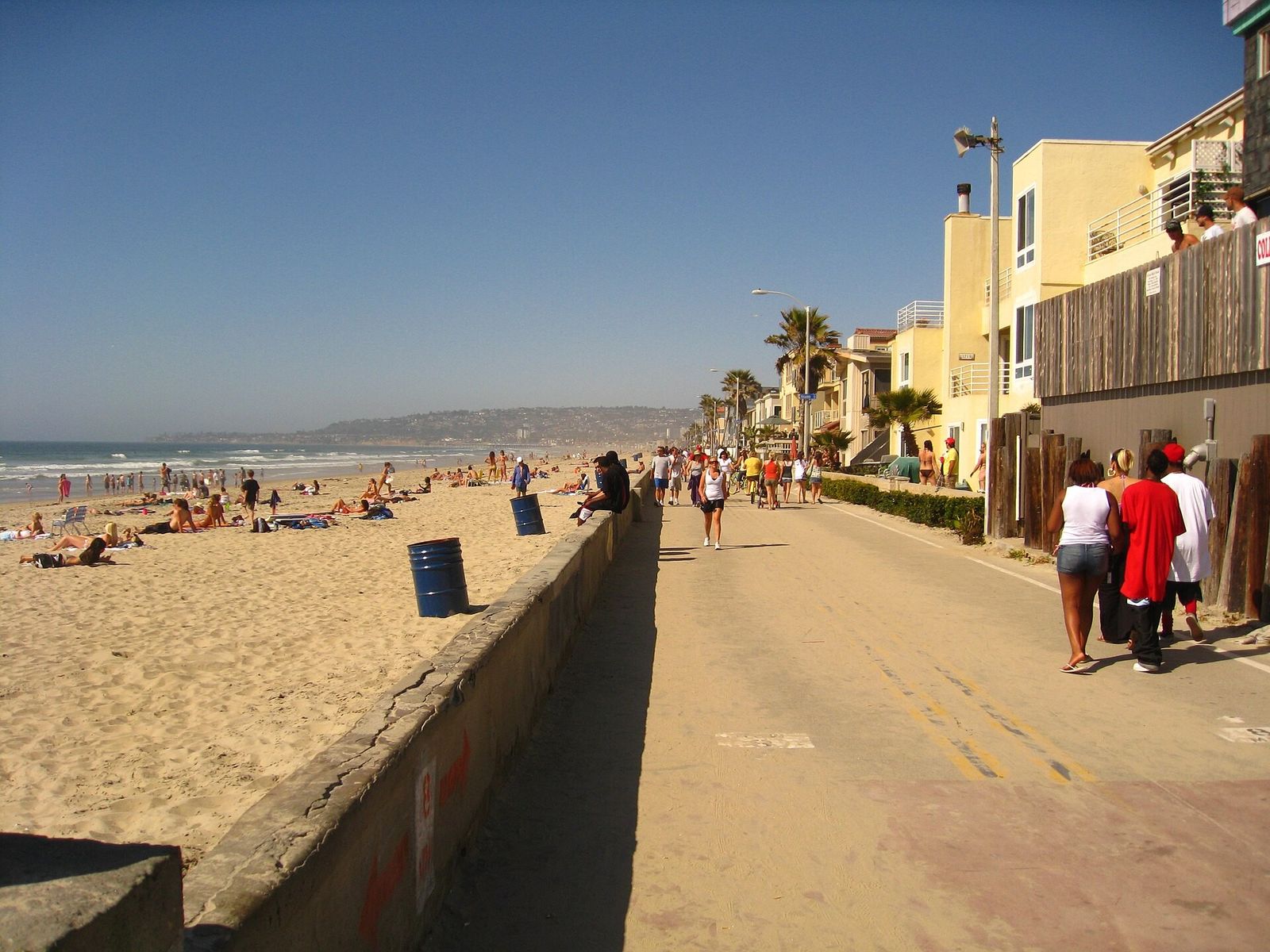 A beachfront boardwalk seen from the sand.