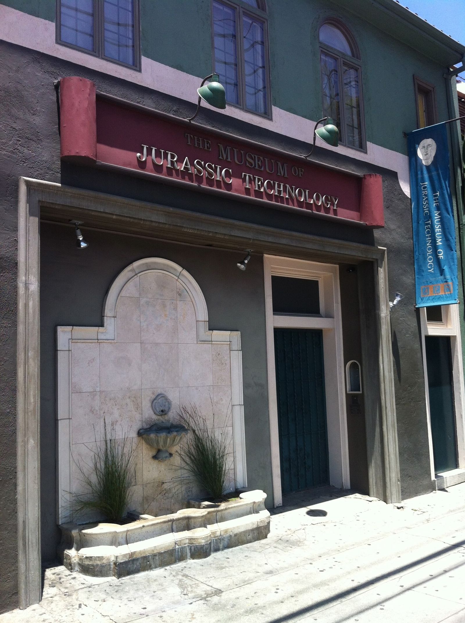 Street-level front of the Museum of Jurassic Technology with its red signboard above the arched doorway