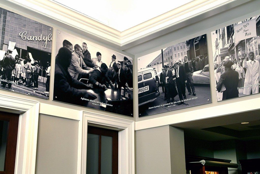 Room with large black-and-white photo murals of the civil rights era wrapping the walls