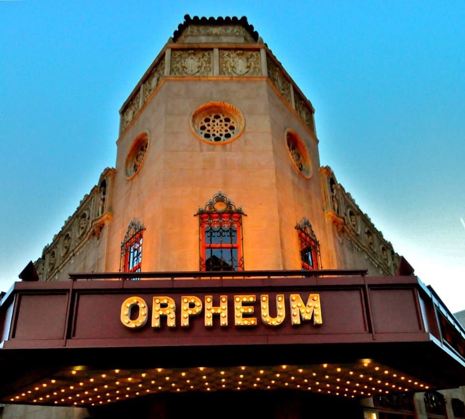 Theatre tower and lit ORPHEUM marquee against a blue evening sky