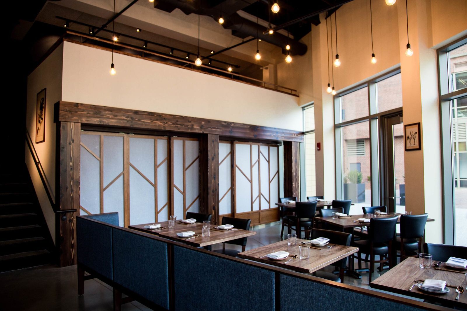 Pagu dining room with rows of tables, large windows and pendant lights