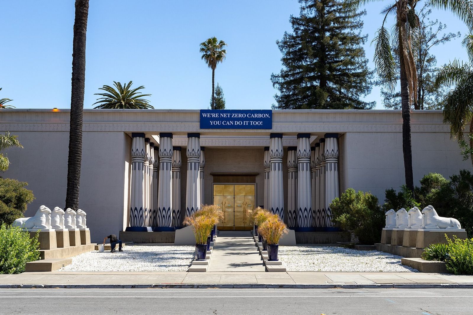 Front of the Egyptian-style museum building with columned entrance and sphinx statues along the walkway