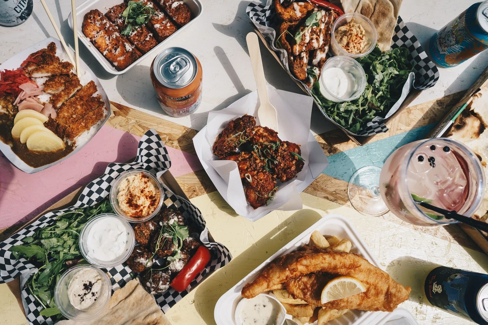 Overhead view of shared plates of food and drinks on a table